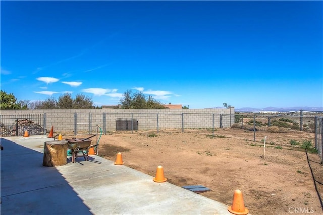 7045 Oak Hill Rd, Oak Hills, CA 92344 - view of yard with a mountain view, a patio, and fence