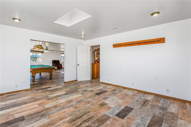 7045 Oak Hill Rd, Oak Hills, CA 92344 - unfurnished room featuring pool table, baseboards, visible vents, a skylight, and wood finished floors