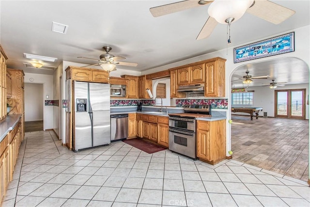 7045 Oak Hill Rd, Oak Hills, CA 92344 - kitchen with a sink, light countertops, ceiling fan, under cabinet range hood, and stainless steel appliances