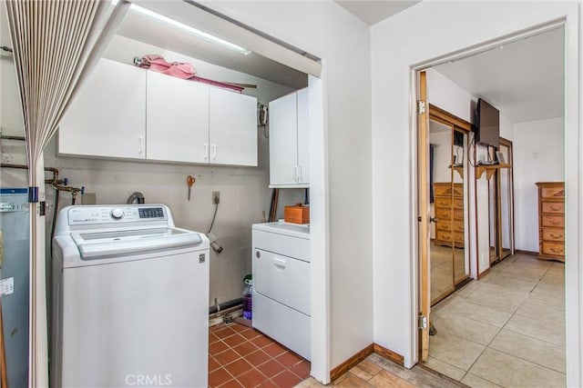 7045 Oak Hill Rd, Oak Hills, CA 92344 - washroom with separate washer and dryer, light tile patterned flooring, baseboards, and cabinet space