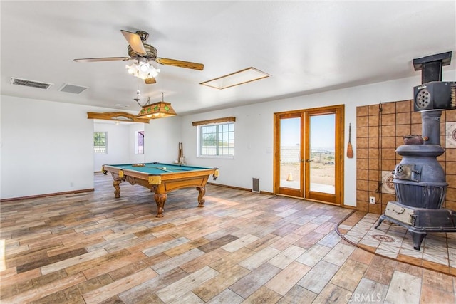 7045 Oak Hill Rd, Oak Hills, CA 92344 - rec room with pool table, french doors, light wood-style flooring, a wood stove, and visible vents