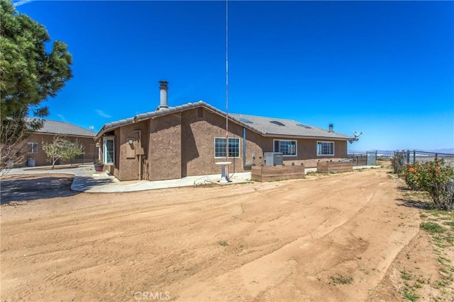 7045 Oak Hill Rd, Oak Hills, CA 92344 - rear view of property with fence and stucco siding