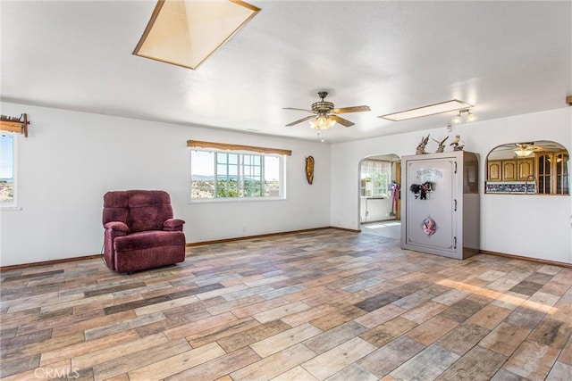 7045 Oak Hill Rd, Oak Hills, CA 92344 - unfurnished room with ceiling fan, arched walkways, wood finished floors, and baseboards