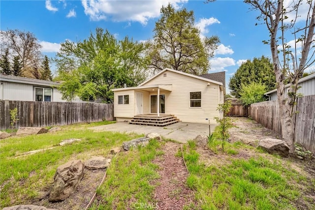 back of property with a patio and a fenced backyard