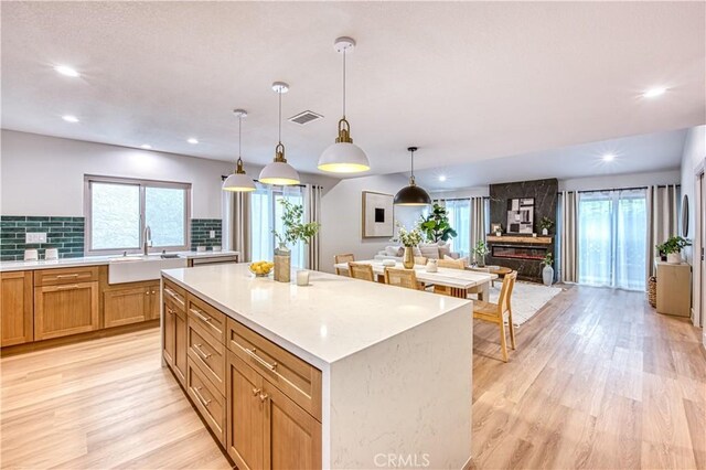 27695 Via Turina, Mission Viejo, CA 92692 - kitchen with light countertops, visible vents, light wood finished floors, and a sink