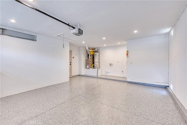 27695 Via Turina, Mission Viejo, CA 92692 - garage with water heater, baseboards, recessed lighting, and a garage door opener
