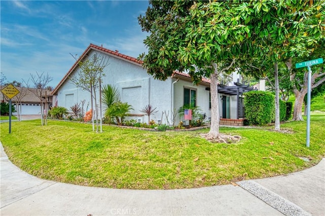 27695 Via Turina, Mission Viejo, CA 92692 - view of side of home with a tiled roof, a yard, and stucco siding