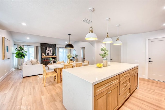 27695 Via Turina, Mission Viejo, CA 92692 - kitchen with light wood-style floors, visible vents, and a kitchen island