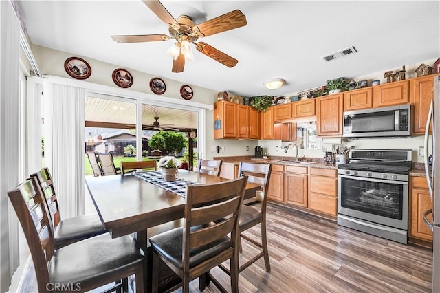 kitchen with a ceiling fan, visible vents, a sink, and appliances with stainless steel finishes