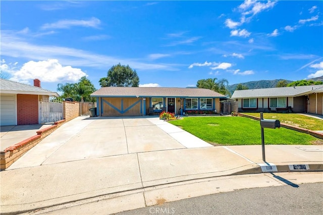 ranch-style house with a gate, driveway, a front lawn, and fence