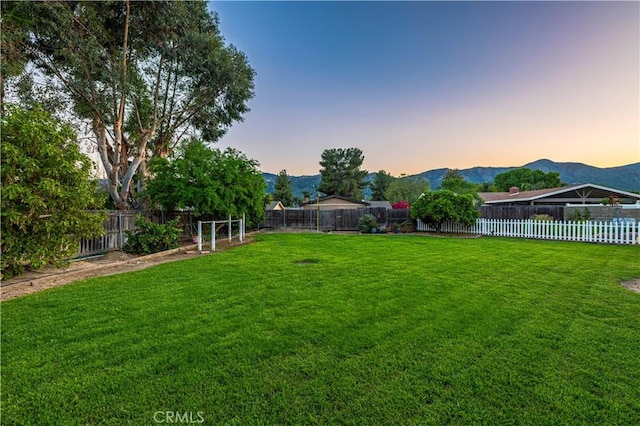 view of yard featuring a fenced backyard and a mountain view