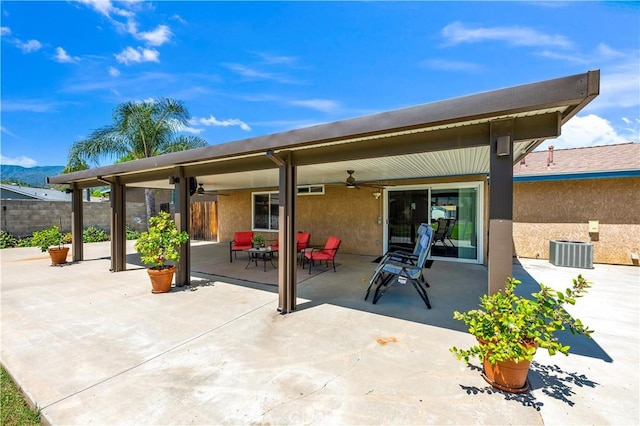 exterior space featuring central AC unit, fence, and ceiling fan