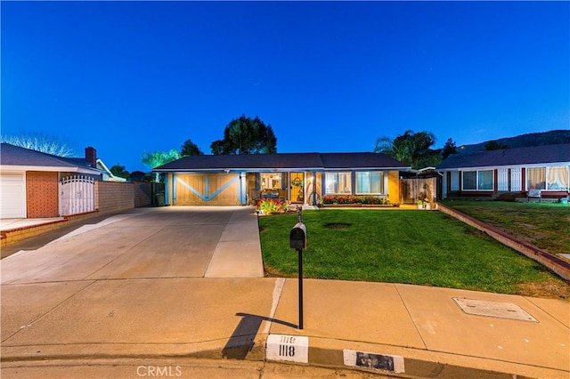 ranch-style home with fence, a front lawn, a gate, and concrete driveway