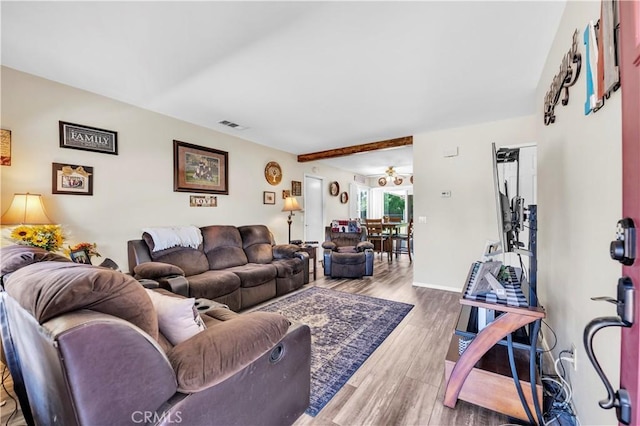 living area with wood finished floors and visible vents
