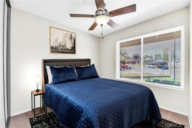 bedroom featuring carpet floors, a ceiling fan, and baseboards