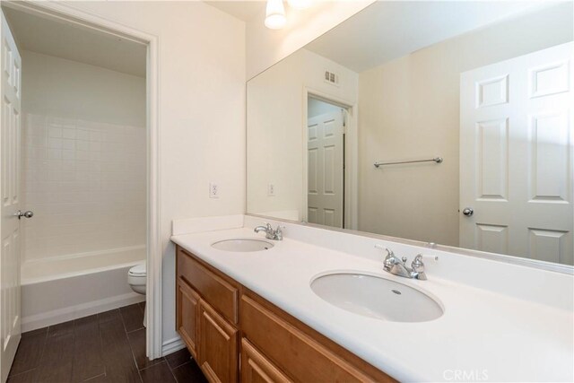 27321 Carlton Oaks St, Murrieta, CA 92562 - bathroom with double vanity, visible vents, a sink, and toilet