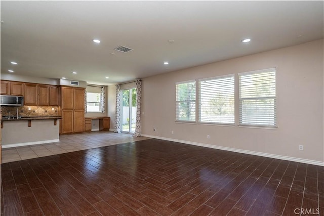 27321 Carlton Oaks St, Murrieta, CA 92562 - unfurnished living room featuring wood finished floors, baseboards, visible vents, and recessed lighting