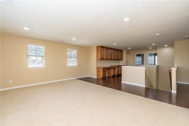 27321 Carlton Oaks St, Murrieta, CA 92562 - unfurnished living room with dark carpet, baseboards, and recessed lighting