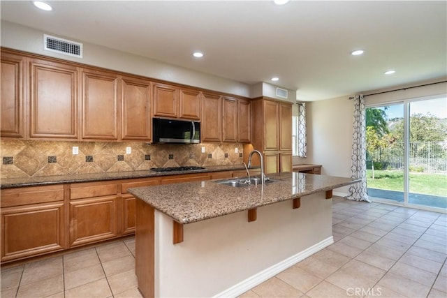 27321 Carlton Oaks St, Murrieta, CA 92562 - kitchen featuring visible vents, recessed lighting, stainless steel microwave, a sink, and brown cabinets