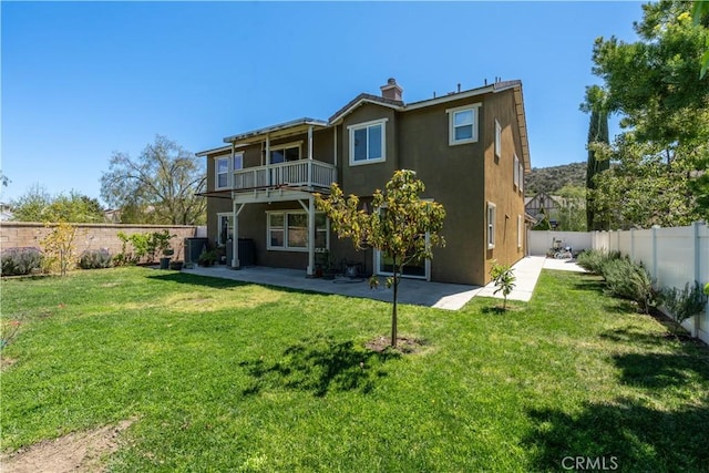 27321 Carlton Oaks St, Murrieta, CA 92562 - rear view of property featuring a balcony, stucco siding, a fenced backyard, and a lawn