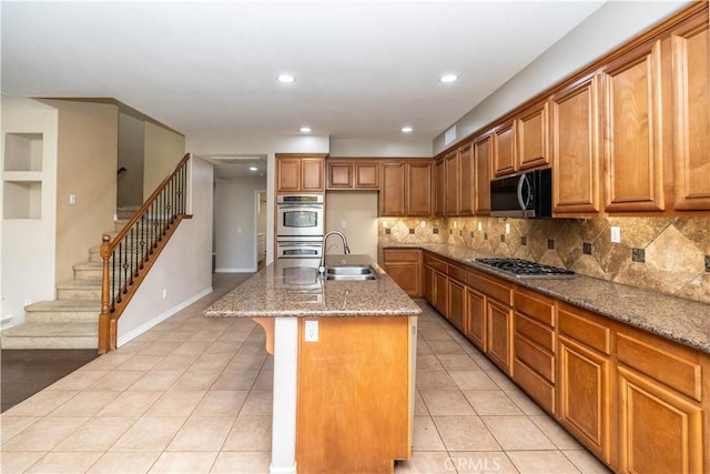 27321 Carlton Oaks St, Murrieta, CA 92562 - kitchen featuring light stone counters, light tile patterned flooring, brown cabinets, appliances with stainless steel finishes, and a sink