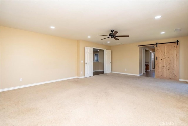 27321 Carlton Oaks St, Murrieta, CA 92562 - spare room featuring light colored carpet, a ceiling fan, recessed lighting, a barn door, and baseboards