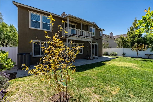 27321 Carlton Oaks St, Murrieta, CA 92562 - rear view of house with a yard, a fenced backyard, stucco siding, and a balcony