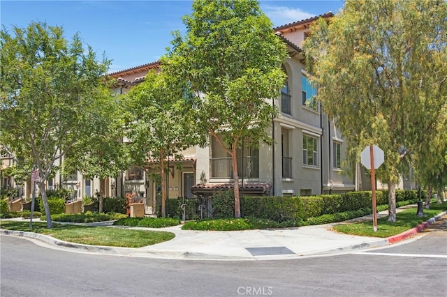 201 Native, Irvine, CA 92618 - view of front of home with a tile roof, stucco siding, and a residential view
