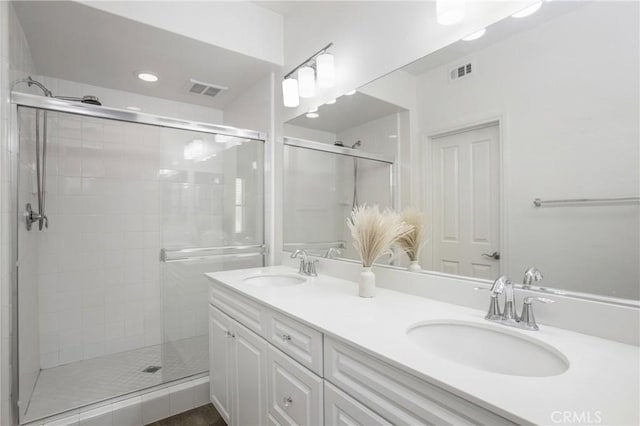 201 Native, Irvine, CA 92618 - full bathroom featuring a shower stall, double vanity, and recessed lighting