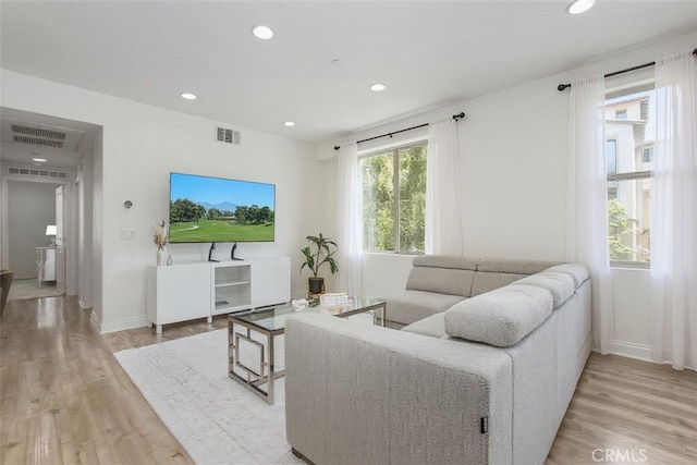 201 Native, Irvine, CA 92618 - living room with light wood-style floors and recessed lighting