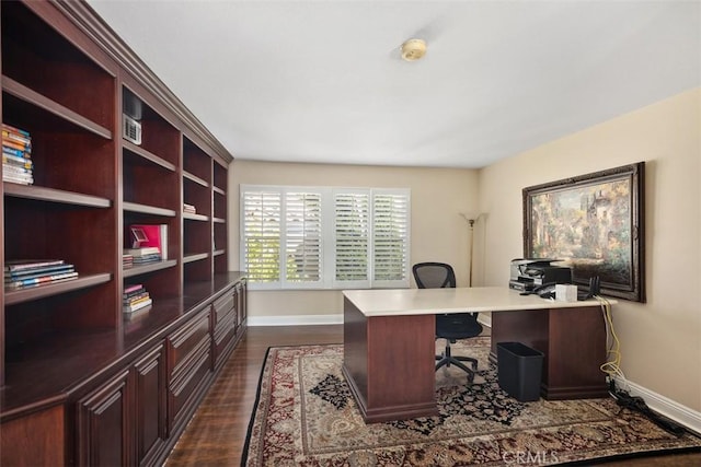 office area with baseboards and dark wood finished floors