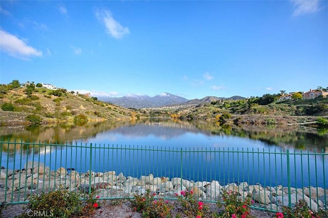 view of water feature featuring fence and a mountain view