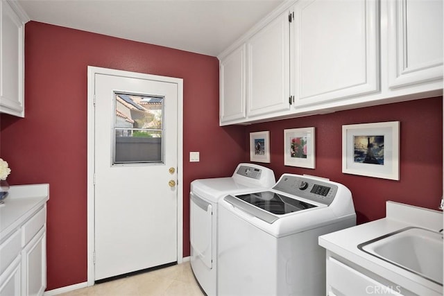 clothes washing area with washing machine and clothes dryer, a sink, and cabinet space