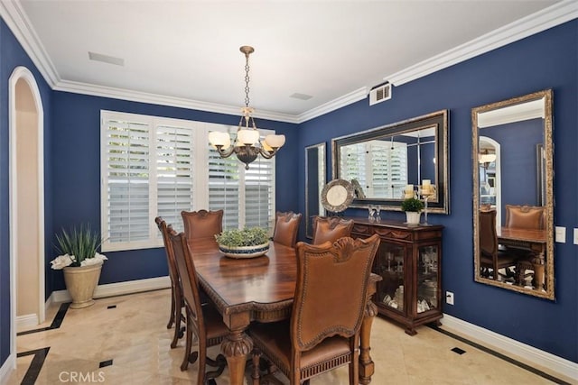 dining space with baseboards, a notable chandelier, and ornamental molding