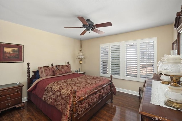 bedroom with a ceiling fan, baseboards, and dark wood-style floors