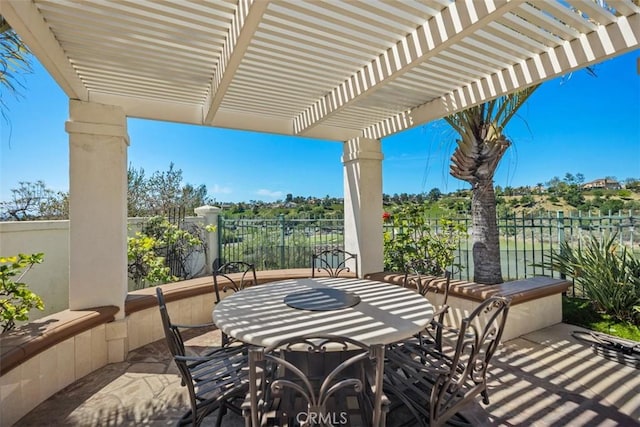 view of patio / terrace with a pergola, outdoor dining area, and fence