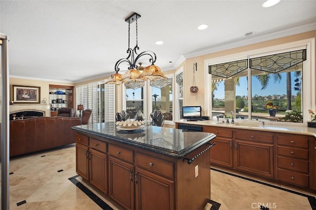 kitchen featuring hanging light fixtures, ornamental molding, a notable chandelier, and a sink