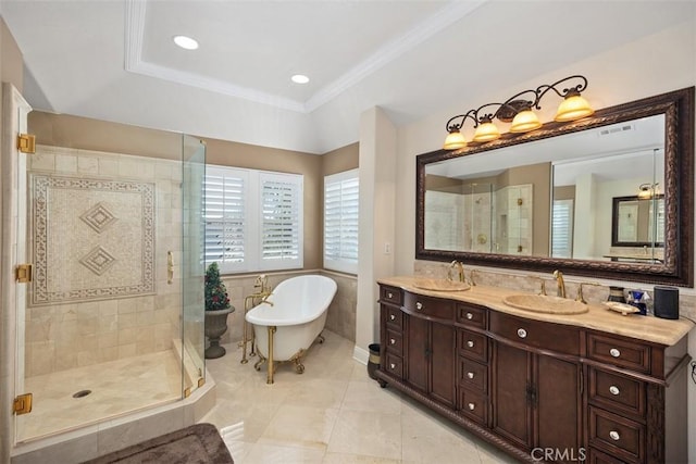 full bathroom featuring a shower stall, a sink, a soaking tub, double vanity, and visible vents