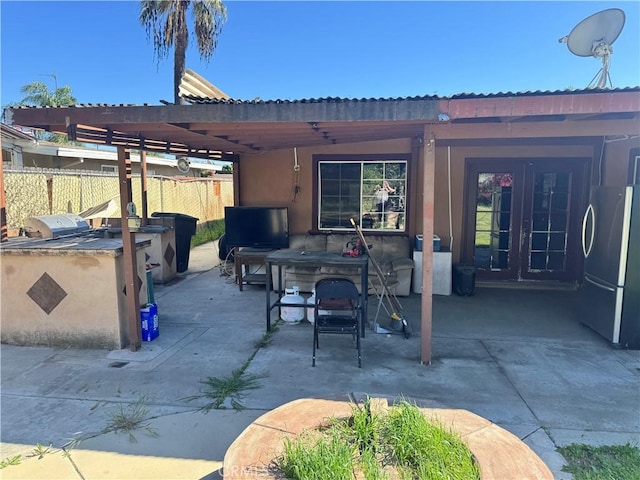 1113 Brewster Dr, Pomona, CA 91767 - view of patio / terrace featuring exterior kitchen, french doors, and fence