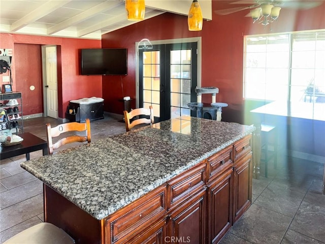 1113 Brewster Dr, Pomona, CA 91767 - kitchen with french doors, beamed ceiling, a ceiling fan, and stone counters