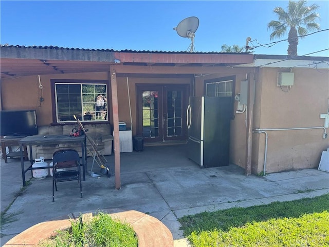 1113 Brewster Dr, Pomona, CA 91767 - rear view of house featuring french doors, a patio area, and stucco siding