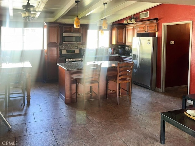 1113 Brewster Dr, Pomona, CA 91767 - kitchen with visible vents, stone tile flooring, appliances with stainless steel finishes, a ceiling fan, and backsplash