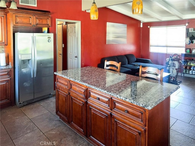 1113 Brewster Dr, Pomona, CA 91767 - kitchen featuring dark stone counters, visible vents, a kitchen island, stainless steel refrigerator with ice dispenser, and beam ceiling