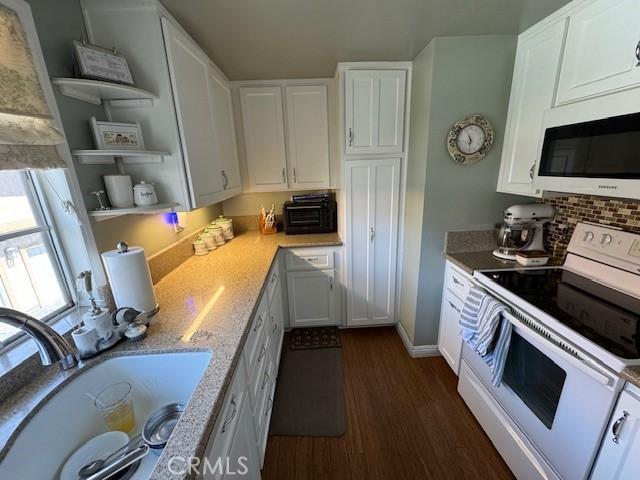 2 Via Pariente, Rancho Santa Margarita, CA 92688 - kitchen with white appliances, a sink, white cabinets, dark wood finished floors, and open shelves
