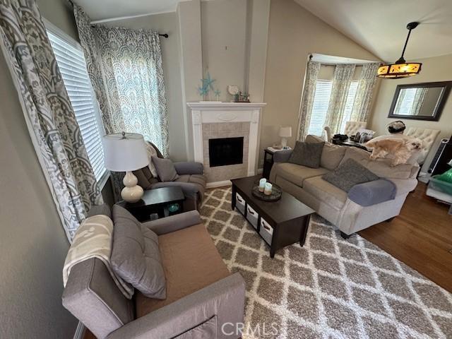 2 Via Pariente, Rancho Santa Margarita, CA 92688 - living area with plenty of natural light, wood finished floors, a tile fireplace, and lofted ceiling