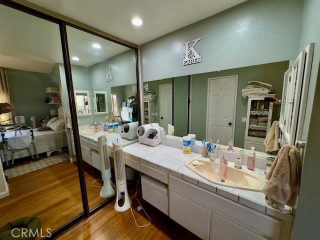 2 Via Pariente, Rancho Santa Margarita, CA 92688 - bathroom featuring connected bathroom, wood finished floors, vanity, and recessed lighting