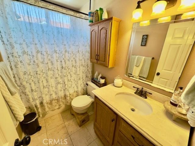 2 Via Pariente, Rancho Santa Margarita, CA 92688 - bathroom with tile patterned floors, a shower with curtain, vanity, and toilet