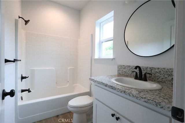 full bath with toilet, vanity, and bathtub / shower combination