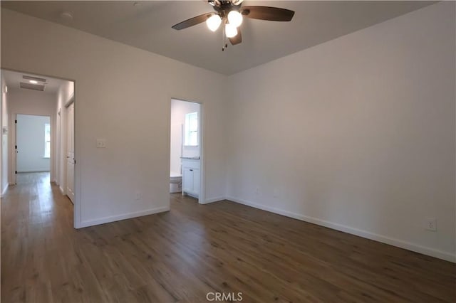 empty room featuring wood finished floors, ceiling fan, and baseboards
