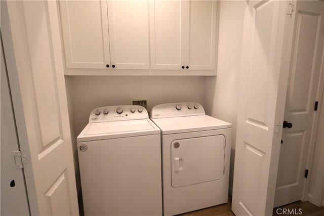laundry area featuring washing machine and dryer and cabinet space